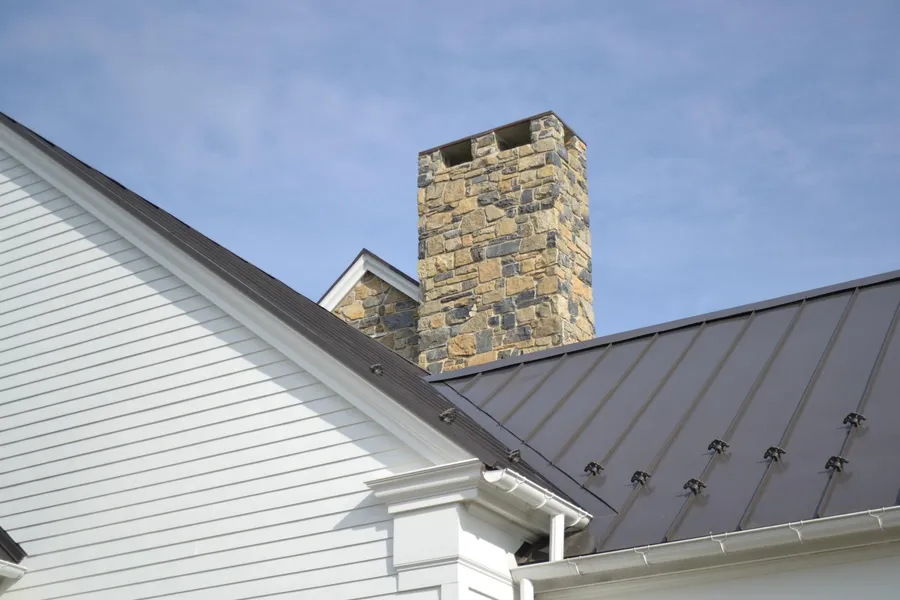 A hand-laid natural stone chimney crafted by Pyle Bros.