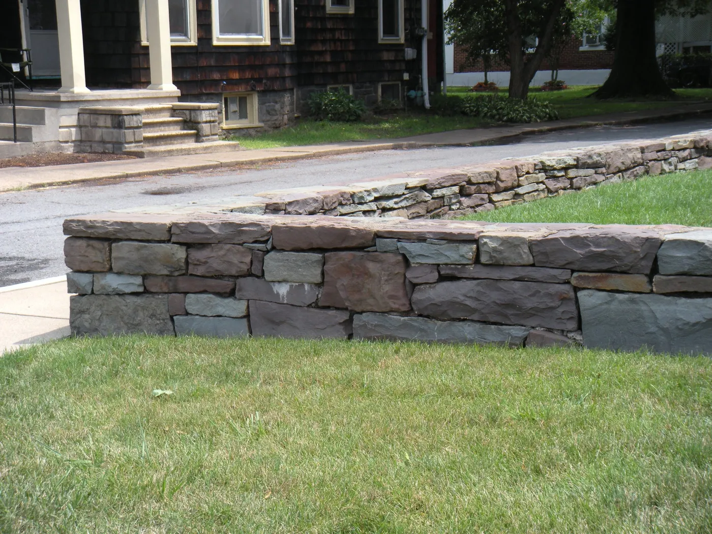 A natural stone retaining wall at the Wahlberg Residence in Sunbury, PA, built by Pyle Bros.